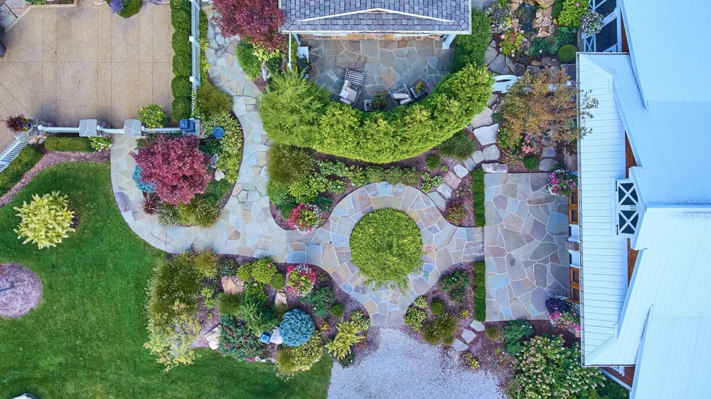 Aerial View of Lush Residential Garden with Stone Patio and Gazebo