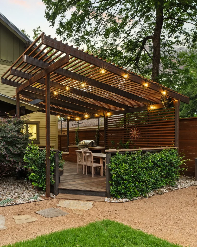 Beautiful composite deck featuring a pergola and dining table