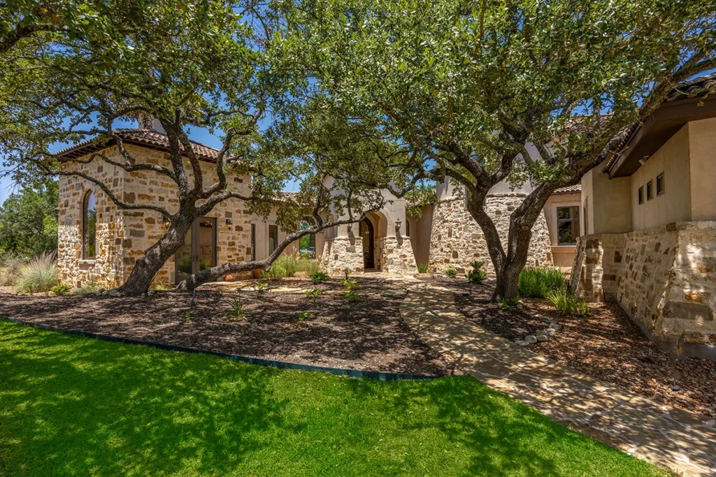 Rustic charm of a sunlit courtyard nestled among ancient oak trees